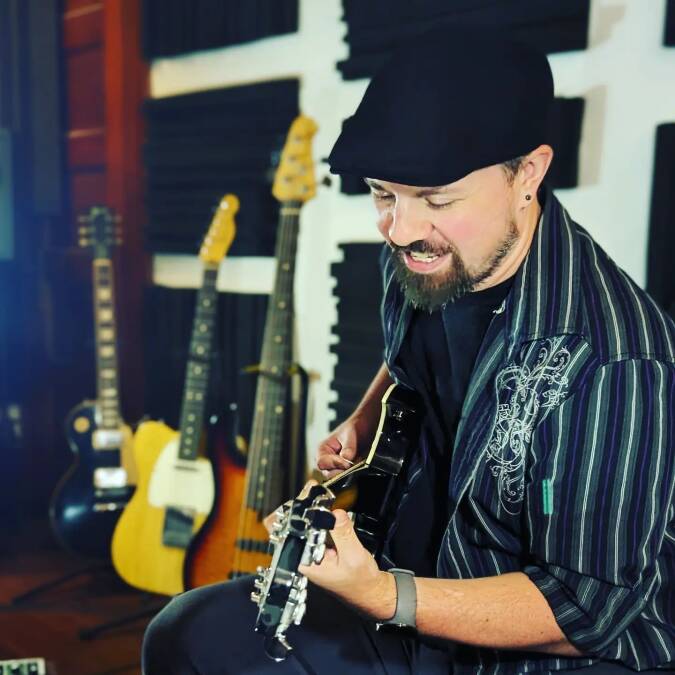 Keegan Han recording punk song in Kansas studio